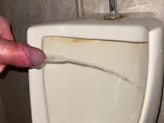 Quick pissing in a public toilet close up