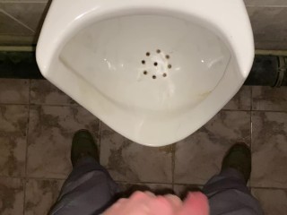 Hands-free pissing in a public toilet from an uncut dick