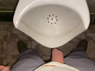 Hands-free pissing in a public toilet from an uncut dick