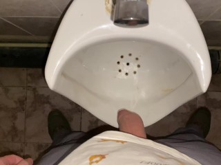 Hands-free pissing in a public toilet from an uncut dick