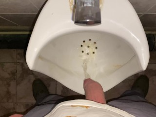 Hands-free pissing in a public toilet from an uncut dick