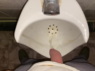 Hands-free pissing in a public toilet from an uncut dick