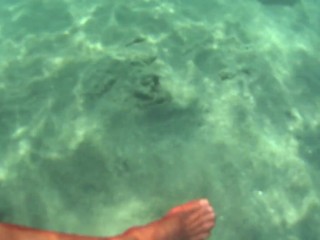 red stocking in the sea at the public beach