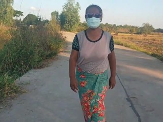 Auntie walks and shows off her breasts on the side of the road.