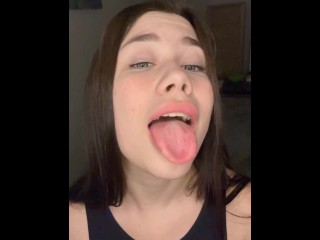 playing with her tits on camera, showing her tongue.