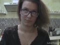 Solo girl with glasses chatting in the kitchen