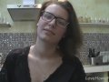 Solo girl with glasses chatting in the kitchen