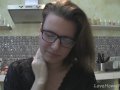 Solo girl with glasses chatting in the kitchen