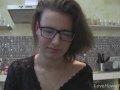 Solo girl with glasses chatting in the kitchen