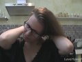 Solo girl with glasses chatting in the kitchen