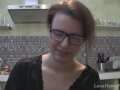 Solo girl with glasses chatting in the kitchen