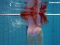 Redhead Simonna showing her body underwater