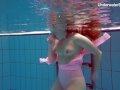 Redhead Simonna showing her body underwater