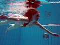 Redhead Simonna showing her body underwater