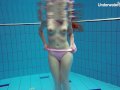 Redhead Simonna showing her body underwater