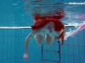 Redhead Simonna showing her body underwater