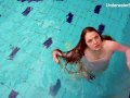 Redhead Simonna showing her body underwater