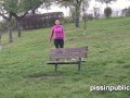 Peeing babes empty their bladders in a park