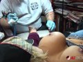 Shyla Stylez gets tattooed while playing with her tits