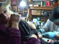 Shyla Stylez gets tattooed while playing with her tits