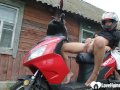 Biker girl masturbates on her red motorcycle