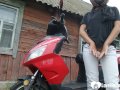 Biker girl masturbates on her red motorcycle