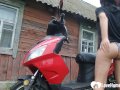 Biker girl masturbates on her red motorcycle